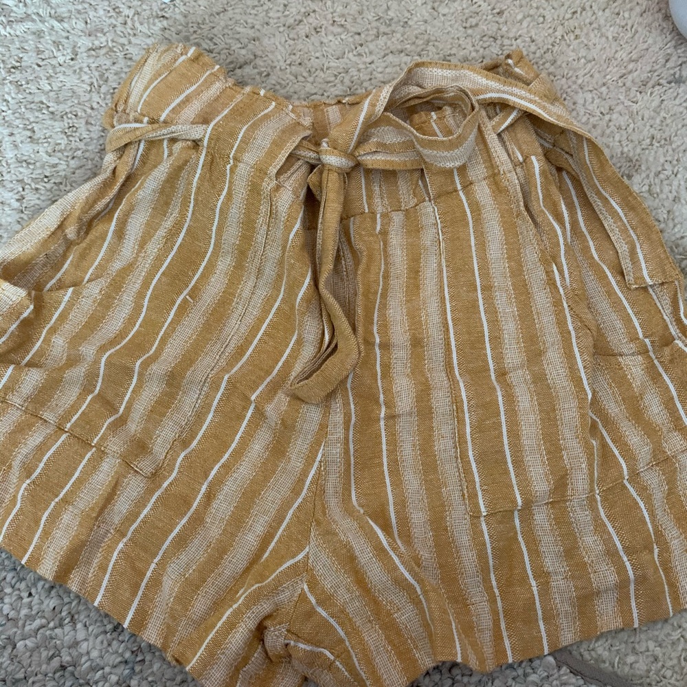 Yellow and white paper bag shorts with pockets.